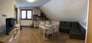a living room with a couch and a table and chairs at Apartmány TAS in Jablonec nad Jizerou
