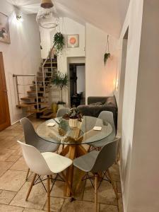 a living room with a glass table and chairs at Woodland, Canal & Lakeside Cottage in Ellesmere