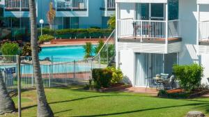 a balcony with a swimming pool in a building at Lousha Bach Dolphin Heads in Eimeo