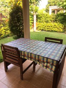 a table with a checkered table cloth on a patio at Casa Seaside Rayong by Chate in Rayong +9 photos