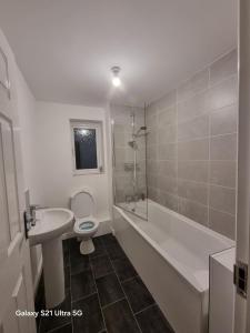 a bathroom with a sink and a toilet and a shower at Beluca homes Acklam in Middlesbrough