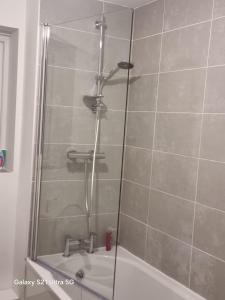 a shower with a glass door in a bathroom at Beluca homes Acklam in Middlesbrough +3 photos
