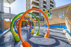 a playground with a row of colorful slides at LAUR HOTELS Experience & Elegance in Didim
