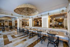 a large dining room with tables and chairs at LAUR HOTELS Experience & Elegance in Didim