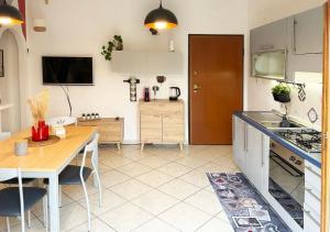 a kitchen with a table and a dining room at Holihome D'Auri in Tortoreto Lido