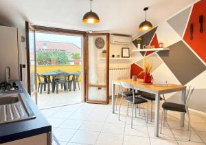 a kitchen with a table and chairs and a dining room at Holihome D'Auri in Tortoreto Lido +27 photos