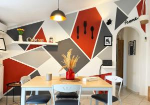 a dining room with a geometric wall at Holihome D'Auri in Tortoreto Lido