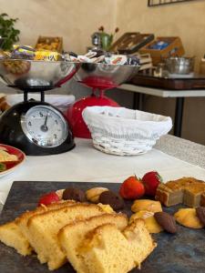 a plate of bread and strawberries on a table at Casa Merano Residence & Restaurant Bibione - New suites in Bibione +2 photos