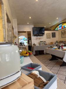 a room with a kitchen with a table and a counter at Casa Merano Residence & Restaurant Bibione - New suites in Bibione