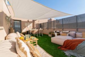 a living room with couches and a tent at Penthouse with Private Terrace & Pool Access in Cornellà de Llobregat