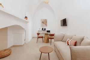 a living room with a couch and a table at Corte Vespro in Ugento