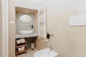 a white bathroom with a sink and a mirror at Corte Vespro in Ugento +105 photos