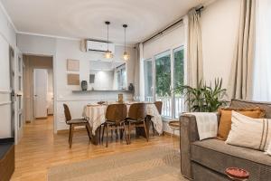 a dining room and living room with a table and a couch at NEW Refurbished Modern Apartment in Barcelona