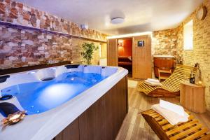 a large bathroom with a large blue tub at Apartmány Andrea s wellness in Zdíkov +57 photos