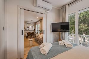 a bedroom with a bed with towels on it at NEW Refurbished Modern Apartment in Barcelona