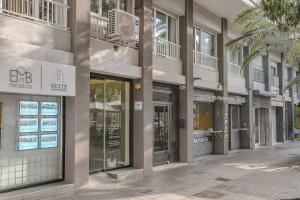 a row of store fronts on a city street at NEW Refurbished Modern Apartment in Barcelona