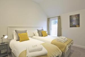 a bedroom with two beds with towels on them at 3 Bed in Snape oc-2wadd in Snape