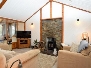 a living room with a fireplace and a tv at 1 Bed in Spalding oc-75073 in Surfleet