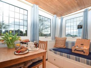a small room with a table and a bed and windows at 1 Bed in Spalding oc-75073 in Surfleet +9 photos