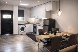 a kitchen with a dining table and a kitchen with a dishwasher at Albufeira New House in Albufeira