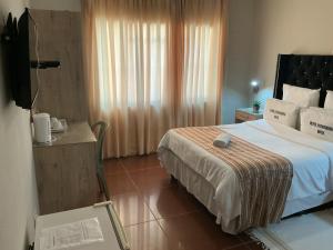 a hotel room with a bed and a window at Punyu International Hotel  +8 photos