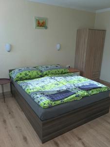 a bed in a room with a bedskirtspectspectssenalsenalsenal at Wellness rezort Maxim Bojnice in Bojnice