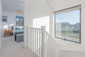 a white room with a staircase and a window at Stonehaven in Warmwell