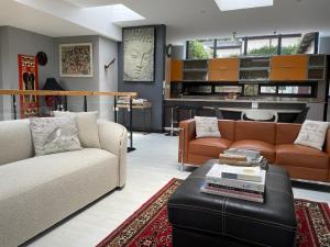 a living room with two couches and a table at Oasis On Lily with OWN Pool in Johannesburg