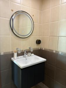 a bathroom with a sink and a mirror at Seaside Apartment Golf Coast in Topola +15 photos