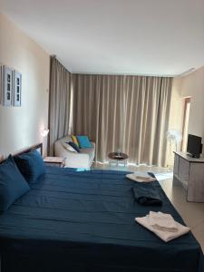 a large blue bed in a room with a couch at Seaside Apartment Golf Coast in Topola