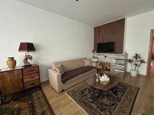 a living room with a couch and a table at MiMi in Brussels