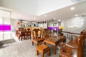 a dining room with wooden tables and chairs at Helen Airport Hotel in Ho Chi Minh City