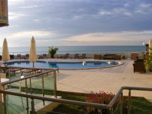 a swimming pool with a view of the ocean at Seaside Apartment Golf Coast in Topola