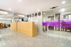 a restaurant with a purple counter and a table at Helen Airport Hotel in Ho Chi Minh City