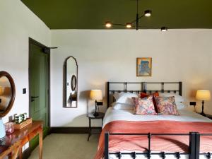 a bedroom with a large bed and a mirror at The Brackenrigg Inn in Watermillock +21 photos