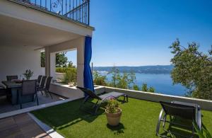 a patio with a table and chairs and a view of the water at Villa Panorama in Omiš
