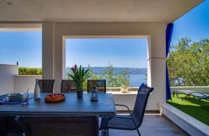 a dining room with a table and a large window at Villa Panorama in Omiš