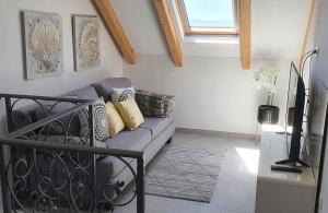 a living room with a couch and a window at Villa Panorama in Omiš