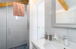 a white bathroom with a sink and a shower at Villa Panorama in Omiš +21 photos
