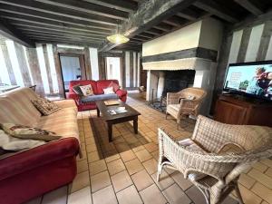 a living room with a couch and a fireplace at Le bourrut in Luglon