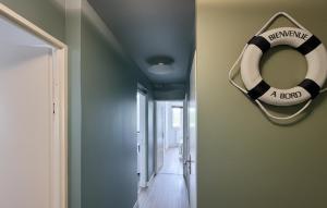 a room with a lifesaver hanging on the wall at Superbe Appartement Vue Mer in Dunkerque +12 photos