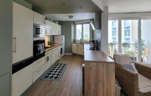 a kitchen with white cabinets and a counter top at Superbe Appartement Vue Mer in Dunkerque