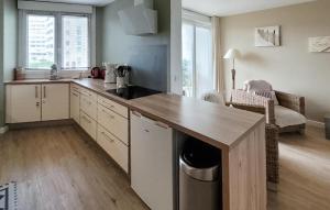 a kitchen with a counter top and a table at Superbe Appartement Vue Mer in Dunkerque