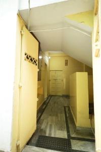 an empty hallway of a building with a room with a door at Hotel Evergreen in Āsansol