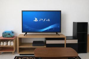 a flat screen tv sitting on a wooden stand at Arumi Experience Tasikmalaya Syariah in Tasikmalaya