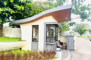 a small tiny house sitting on the side of a street at Arumi Experience Tasikmalaya Syariah in Tasikmalaya