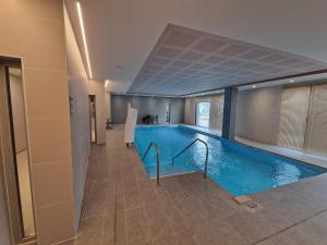a swimming pool in a hotel room with a pool at DOMITYS - Les Cristaux in Le Creusot