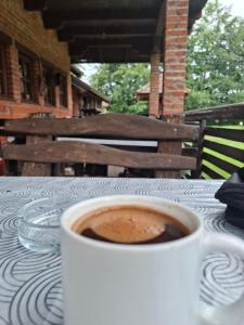 a cup of coffee sitting on a table at Vikendica Tavna in Bijeljina