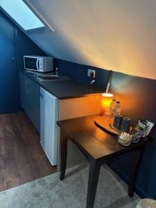a small kitchen with a table with a lamp on it at Hotel Plas Hyfryd in Narberth