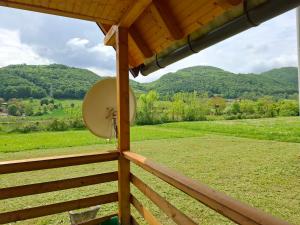 a view from the porch of a cabin with mountains in the background at Vikendica Tavna in Bijeljina